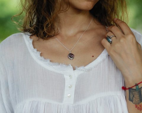 necklace on a woman in a white blouse