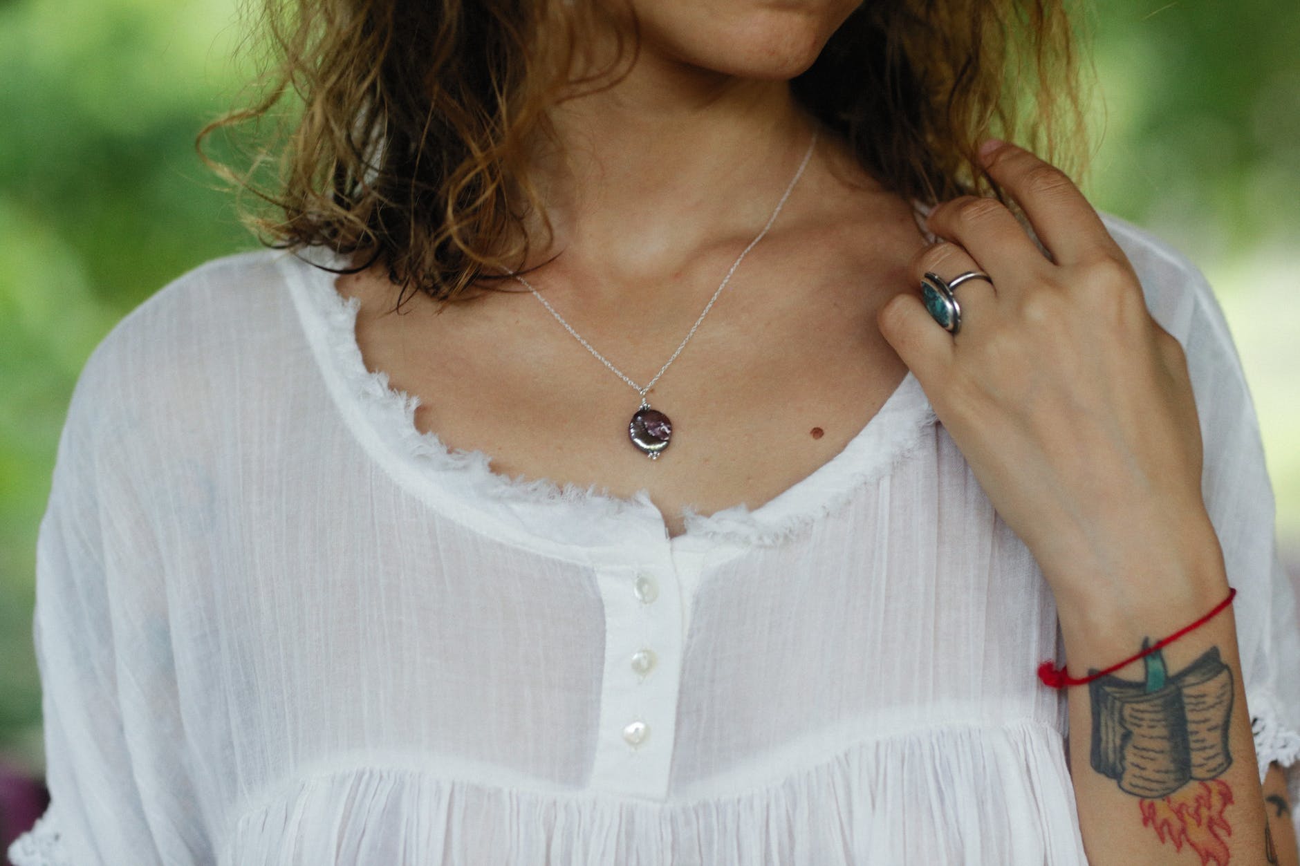 necklace on a woman in a white blouse