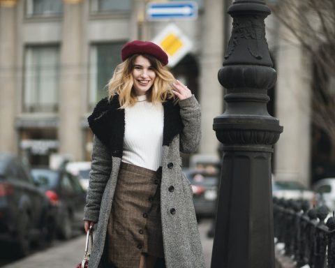 woman standing near post