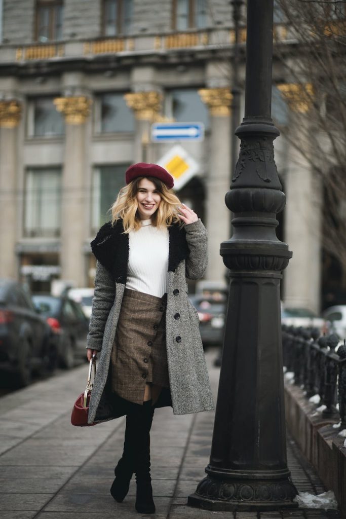 woman standing near post