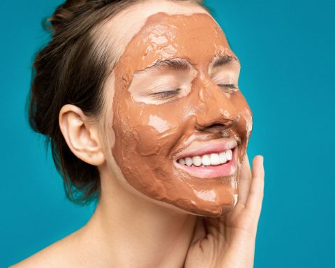 woman with clay mask on face