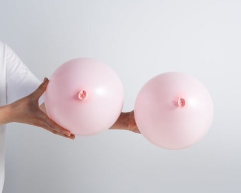 a person holding pink balloons