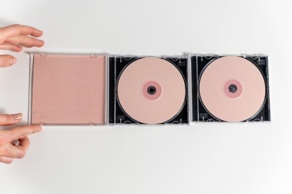 a compact discs on white surface