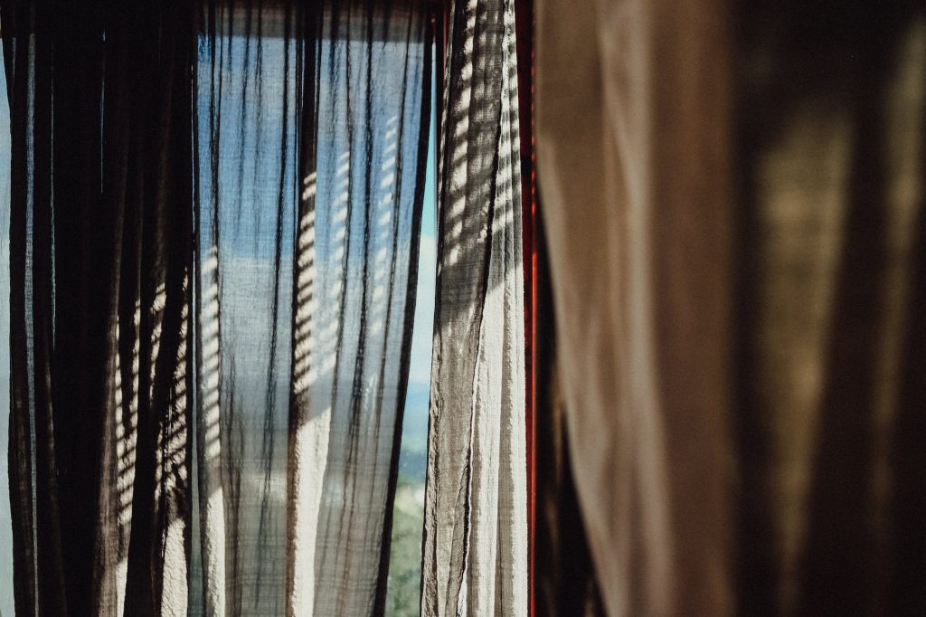 focus photography of brown curtain