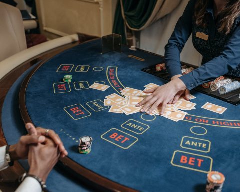 a woman dealer holding cards