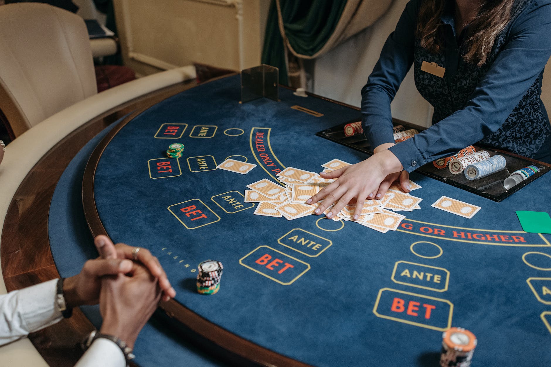 a woman dealer holding cards