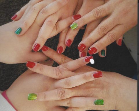 women holding hear hands showing their nail polishes